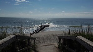 A wooden pathway leading to a beach with a wooden jetty extending into the ocean. - Tip Ellen on Pawleys Island - Second Row, Pet Friendly (Pawleys Island)