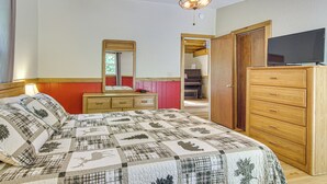 A bedroom with a bed, a dresser, a television, and a ceiling fan. - 20-Acre Cabin w/ Pond: 5 Mi to Biltmore Estate! (Asheville)