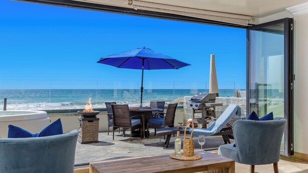 A balcony with a view of the ocean, a grill, and outdoor furniture. - Top Notch Coastal Getaway P813-2 (Oceanside)