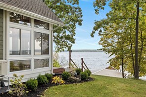 A house with a large bay window overlooking a body of water. - Pine Ridge:"A True Gem" (Geneva)