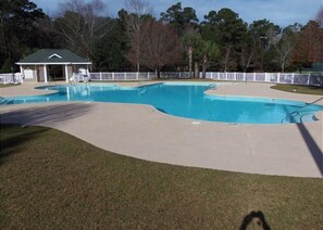 A swimming pool with a curved design, surrounded by a white fence and a covered pavilion. - TB 13D 3Br/3Bath unit super nice with great view on golf course (Pawleys)