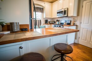 Fridge, microwave, stovetop, coffee/tea maker