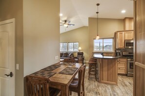 Enjoy cooking in this well-equipped kitchen with a central island, sink, and stovetop.