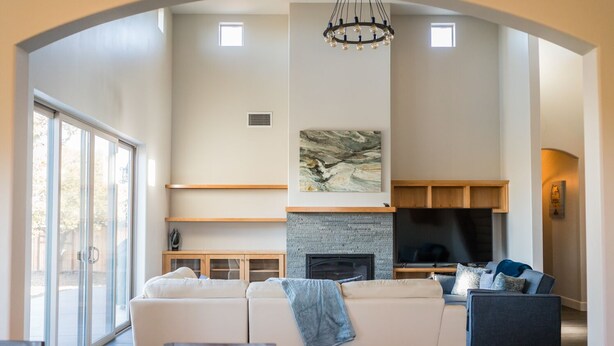 A spacious living room with a fireplace, a large TV, and a comfortable seating area.