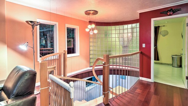 A multi-level interior with a staircase, a chandelier, and a view through a window. - Downtown Anchorage Home, 1 Block to Coastal Trail! (Anchorage)