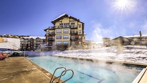 A hotel with a pool area, including a hot tub and lounge chairs. - Ski-In/Ski-Out Access: Mtn-View Granby Condo! (Granby)