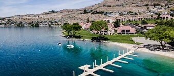 Lake and pool-view condo with beach access, 5 pools, hot tub, & balcony