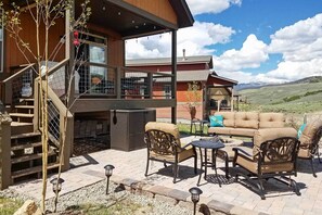 A patio area with outdoor furniture, a staircase, and a view of the mountains. - Patio, Fire Pit, & Ski Mountain View: Granby Home (Granby)
