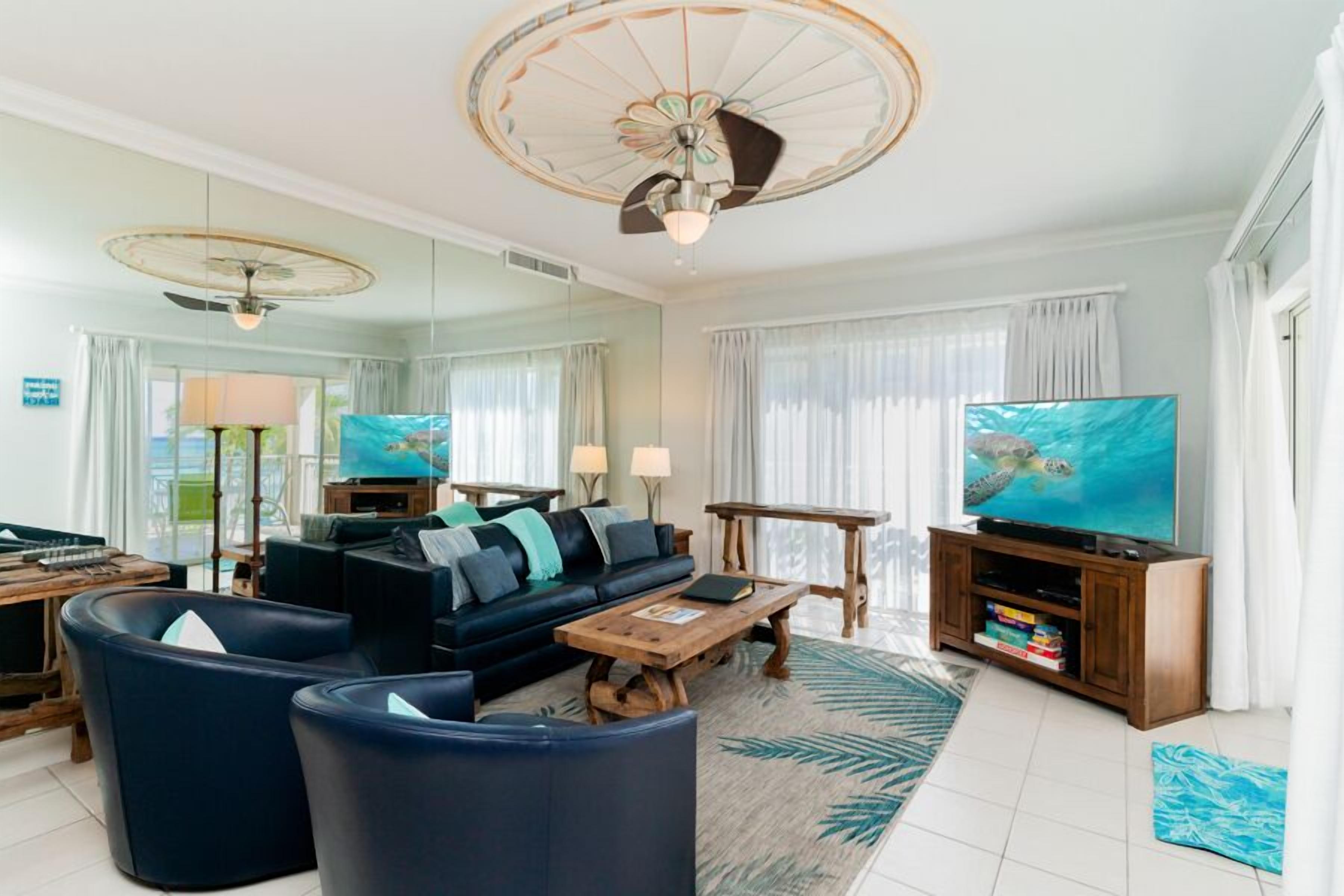 A modern living room with a sofa, coffee table, and TV stand.