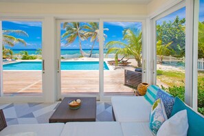 Screened porch with walk-out access to the private pool deck. 