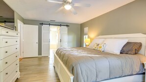 A bedroom with a bed, a dresser, a ceiling fan, and a door leading to another room. - 3 Mi to Dunnellon Historic District: Home w/ Lanai (Dunnellon)