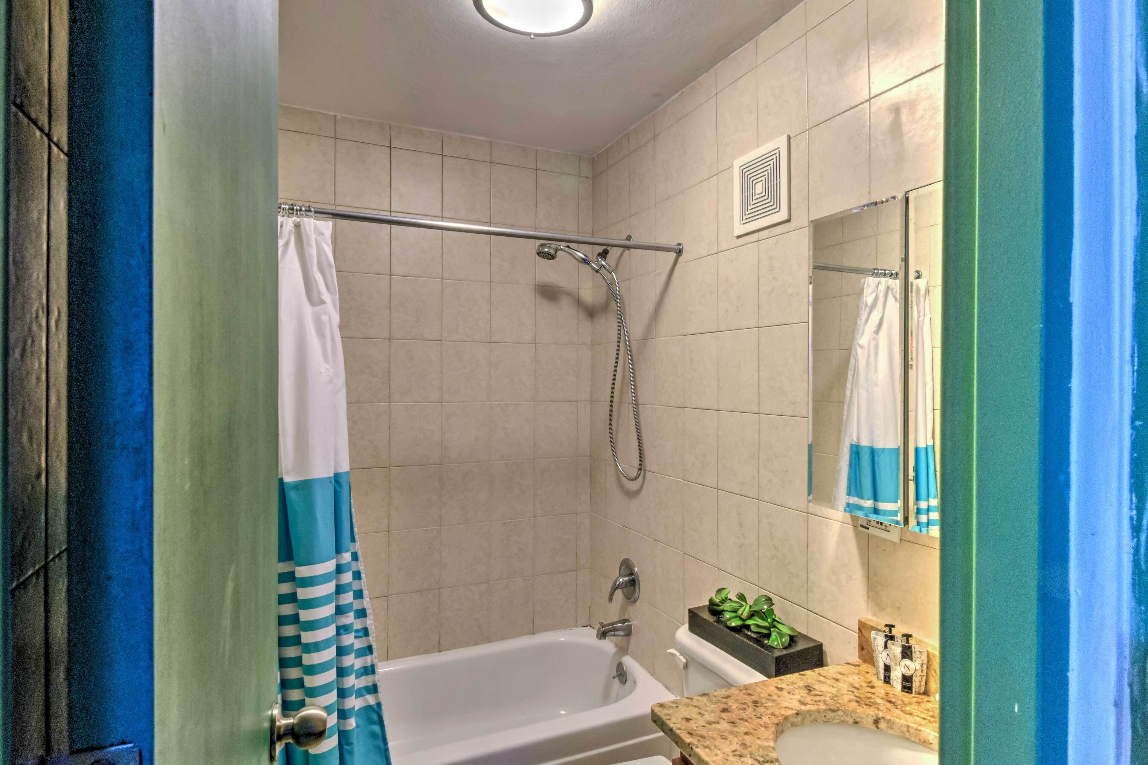 A bathroom with a bathtub, a shower, a toilet, and a sink.