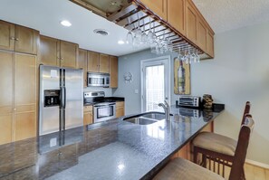 Enjoy cooking in this well-equipped kitchen with a central island, oven, and ample storage.