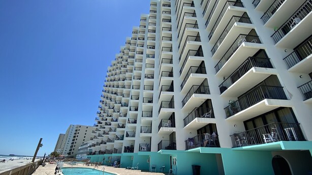 A high-rise hotel with multiple balconies, a pool area, and a beach view. - LARGE AND LOVELY! LOTS OF ROOM IN THIS 3 BEDROOM CONDO RIGHT ON THE OCEAN! (Murrells Inlet)