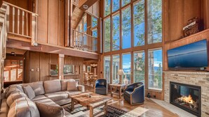 A spacious living room with a large sectional sofa, a fireplace, and a television. - View at Dollar Point by Tahoe Getaways -  Lake Views in Tahoe City (Tahoe City)