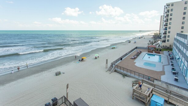 A beachside hotel with a pool area, beach access, and a view of the ocean. - OCEANFRONT LARGE 2 BEDROOM CONDO (Murrells Inlet)