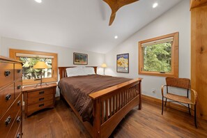 Relax in this serene bedroom with a comfortable bed, large window, and natural views of the outdoors.
