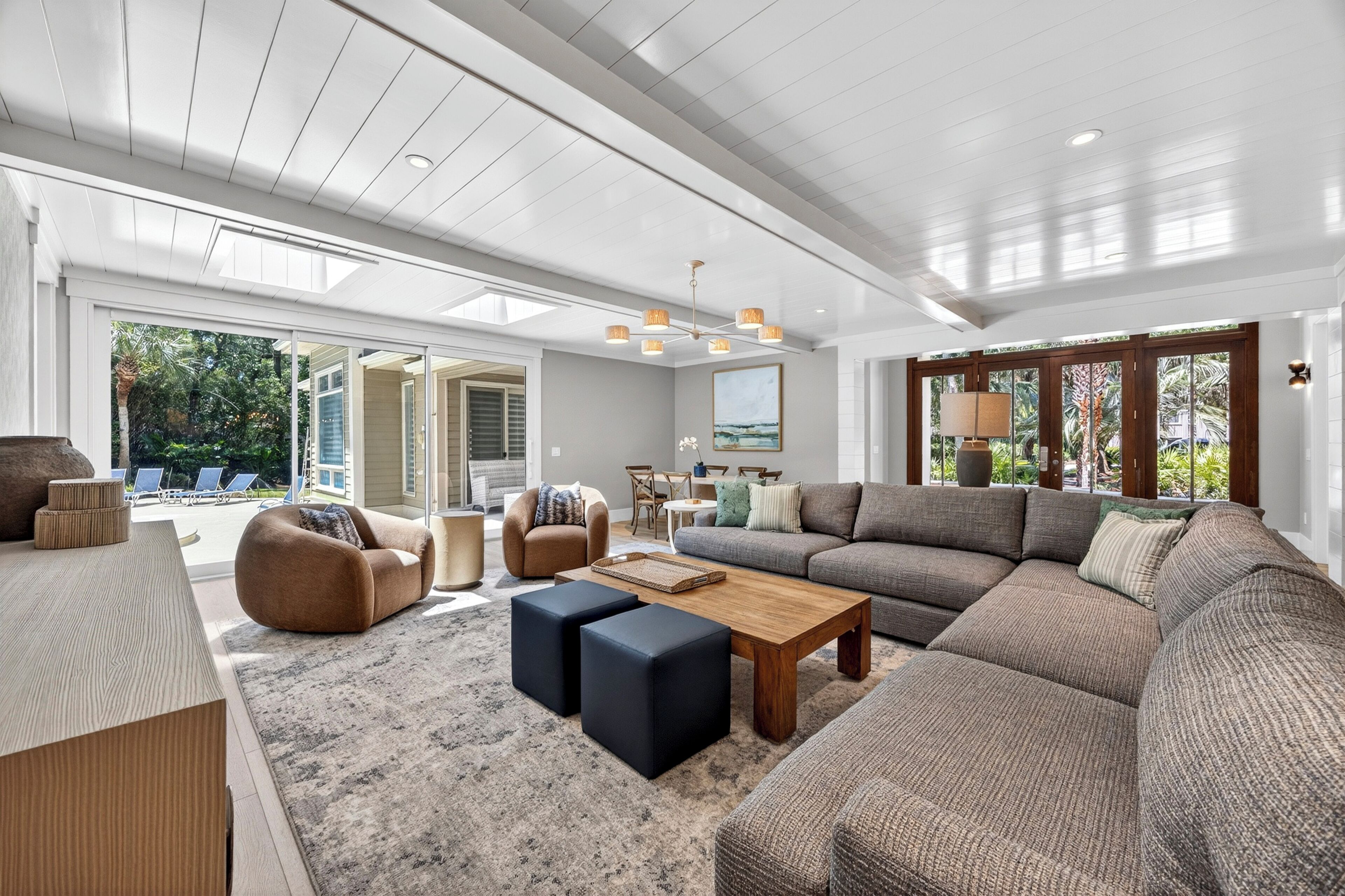 A spacious living room with a large sectional sofa, a wooden coffee table, and a comfortable seating area.