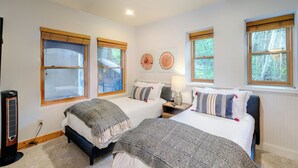 A bedroom with two beds, a heater, and windows with wooden blinds. - 3-Bedroom Private Mountainside Condo (Mountain Village)