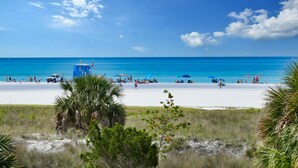 A beach with a lifeguard tower, umbrellas, and people enjoying the sand and water. - 🌴 Villa Vista Mare | Gulf Views, Semi-Private Pool + Steps to Siesta Beach (Siesta Key)