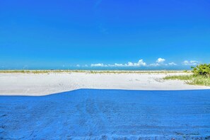 A beach with a clear sky and calm sea.