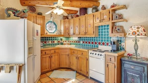 A kitchen with wooden cabinets, a white refrigerator, a stove, and a tiled backsplash. - 6 Mi to Texas Tech: Studio w/ Shared Pool & Grill (Lubbock)