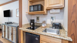 A compact kitchen with a microwave, toaster, and coffee maker. There is a sink and a dishwasher. - Updated Hotel Room With Kitchenette at the Mountainside Inn (Telluride)