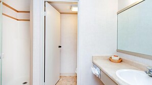 A bathroom with a white sink, a mirror, and a towel rack. - Mountainside Inn Riverside Room With Split-King Bed (Telluride)