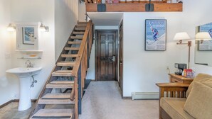 A staircase leading to a loft, a sink, a couch, and a framed poster on the wall. - Cozy Private Lofted Room in Great Telluride Location (Telluride)