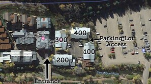 Residential area with numbered lots and parking, situated near the San Miguel River.