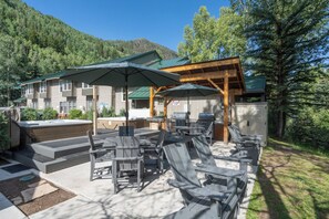 A patio area with outdoor seating and a barbecue setup.