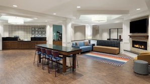 A modern living space with a kitchen, dining area, and seating area.