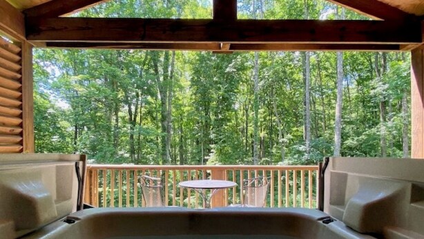 A hot tub in a wooden cabin with a view of a forest. - A-Frame #17 - Hosted by The Chalets (Logan)