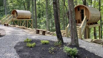 Treehouses nestled among the forest, offering a serene escape with a door, window, and stairs leading to a peaceful retreat.