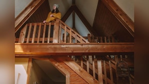 A wooden attic with a sloped ceiling and a balcony. - A-Frame #18 - Hosted by The Chalets (Logan)