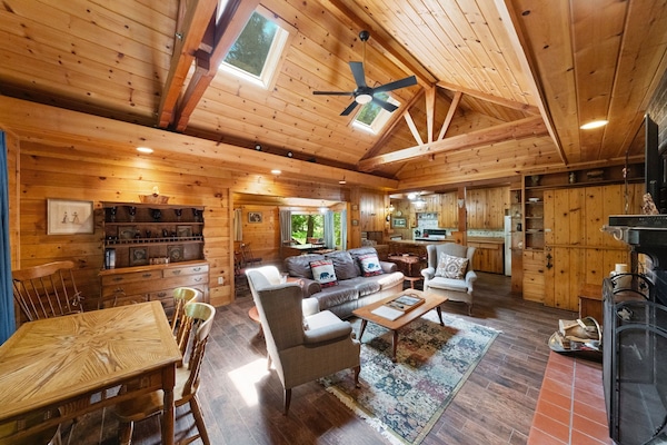 The living room features a charming fireplace and a cozy mounta - The living room features a charming fireplace and a cozy mountain cabin ambiance.