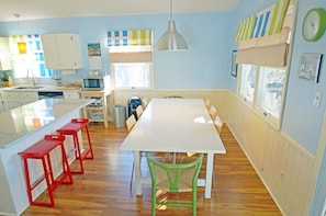 Enjoy meals in the kitchen with a central island, microwave, and sink, and dine at the adjacent table with comfortable seating.