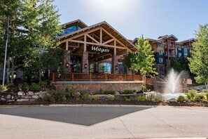 A Westgate hotel with a prominent entrance, stone facade, and a water feature. - Westgate 4616 AB (Park City)