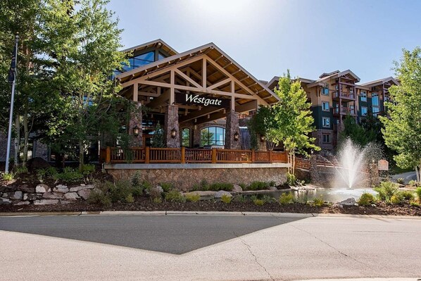 A Westgate hotel with a prominent entrance, stone facade, and a water feature. - Westgate 4616 AB (Park City)