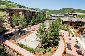 A resort with multiple-story buildings, outdoor seating areas, and a tennis court. - Westgate 4616 AB (Park City)