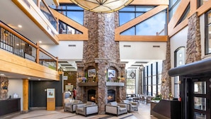 A spacious lobby with a high ceiling, a stone fireplace, and multiple seating areas. - Labor Day Sale - Limited Time Offer, Save up to 30% (Park City)