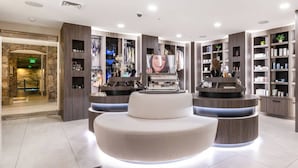 A modern hotel lobby with a central seating area, a reception desk, and a variety of amenities including a clothing rack, a vanity, and a bookshelf. - Labor Day Sale - Limited Time Offer, Save up to 30% (Park City)