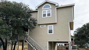 A two-story house with a front porch, a staircase, and a small deck area. - OS760- Close To Beach, 4BRs, Private Pool, Bubbling Hot Tub and Dog Friendly! (Corolla)