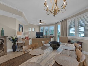 Enjoy meals with friends and family at the large dining table, surrounded by comfortable seating and natural light.