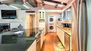 A modern kitchen with a built-in oven, stainless steel appliances, and a wooden floor. - Restful Winnsboro Family Home: Walk to Main Street (Winnsboro)