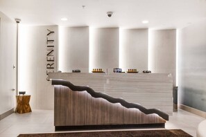 A reception desk with a modern design, a digital clock, and a sign that reads 'FREEDOM'. - Westgate 4606 (Park City)