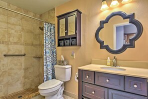 A bathroom with a shower, toilet, vanity, and a large mirror. - Kihei Condo: Steps to Kalepolepo Beach Park! (Kihei)