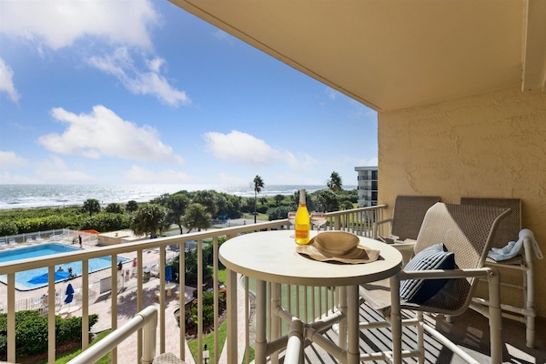 Enjoy breathtaking direct oceanfront views from your private balcony, perfect for relaxation.