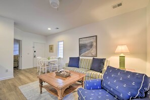 A living room with a sofa, a coffee table, a lamp, and a painting on the wall. - Sunset Beach Retreat - Monthly Rentals Welcome! (Sunset Beach)