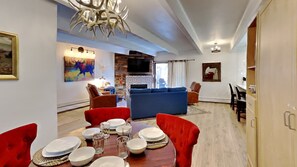 Relax in this stylish living space with a cozy fireplace, dining area, and comfortable seating.